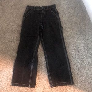 Black baggy ish jeans with white embroidered